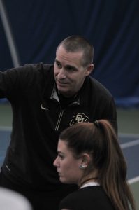 Women’s Tennis Head Coach Blake Mosley gives some pointers during a match. 