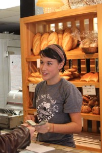Junior Hailey Moore accepts money for an order at Stick Boy Bread Co. on Thursday morning. The bakery has been in Boone for 11 years and regularly donates to charities, non profits and churches in the area. Paul Heckert | The Appalachian