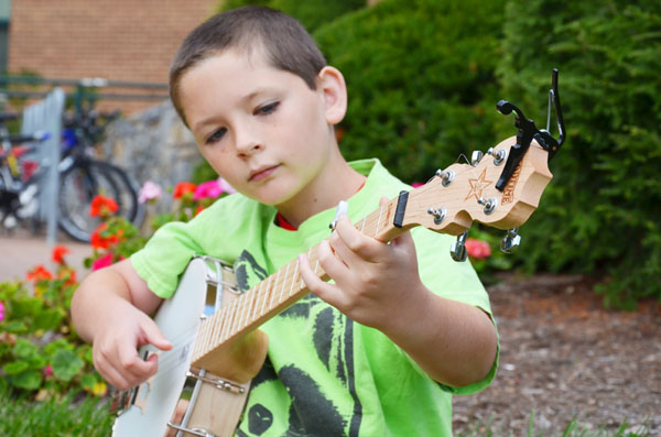 Ten-year-old Liam Purcell, son of Professor William Purcell, can play five instruments and has played on King street and at other venues. At Septembers First Friday Art Crawl, Liam Purcell made $102 playing banjo on the street. Michael Bragg | The Appalachian