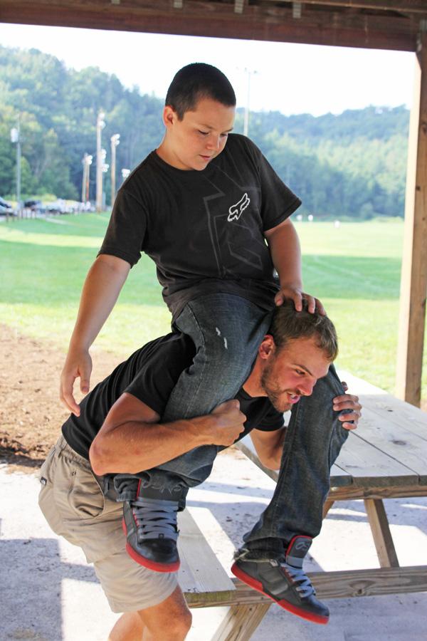 Senior recreation management major Brett Smith lifts his little brother Dylan Johnson onto his shoulder. Brett and Dylan have been paired together for a year through the Western Youth Network. Paul Heckert | The Appalachian