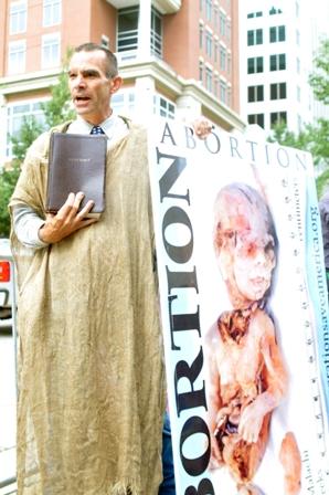 Alan Hoyle protests outside the first day of the Democratic National Convention, held this year in Charlotte. Hoyle referred to some in the crowd as "sinners" and spoke against abortion. Photo: Jason Sharpe | The Appalachian