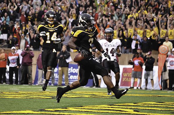 Senior running back Steven Miller races down the field with the ball in Saturday nights match against Montana. The Mountaineers emerged victorious with a score of 35-27. Justin Perry | The Appalachian