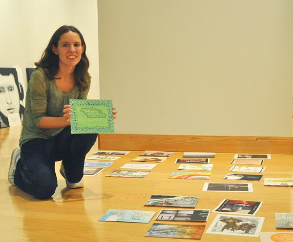 Senior studio art major Kelly Ensley poses with her artwork for the Artistic Rebuttal Book Project exhibition. The exhibit, located in Looking Glass Gallery, is currently in the installation process and will be available for viewing on Monday. Maggie Cozens | The Appalachian