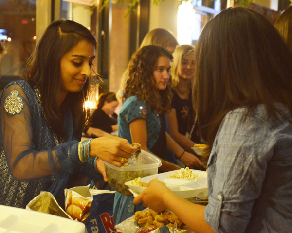 Senior biology major Puja Gosai serves a student during Eid-al-Adha event held by the Muslim Student Association Friday evening in the Solarium. The event invited all students to come and enjoy an authentic middle eastern meal while raising awareness for the conflict in Syria. Maggie Cozens | The Appalachian