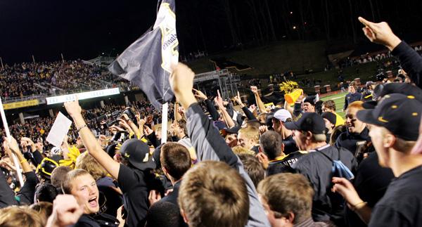 Students storm the field after The Mountaineers took the Paladins for a 33-28 win on Saturday. Paul Heckert | The Appalachian