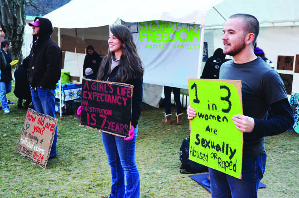 Freshman undecided Antonia Meyers stands with sophomore international criminal justice major Jesse Wilson for the Stand for Freedom event on Sanford Mall Wednesday evening. The event, held by the International Justice Mission, invited all Appalachian students to stand all night to raise awareness for slavery taking place around the world today. Maggie Cozens | The Appalachian