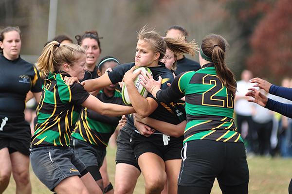 A member of the womens rugby team breaks through several defenders in a match during Rucktoberfest last semester. The men and womens teams are gearing up for the spring season.