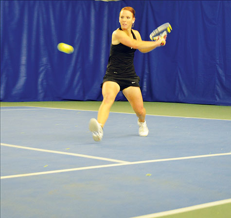 Senior Ellie Linsell backhands the tennis ball during her singles match against the College of Charleston. Aniesy Cardo | The Appalachian