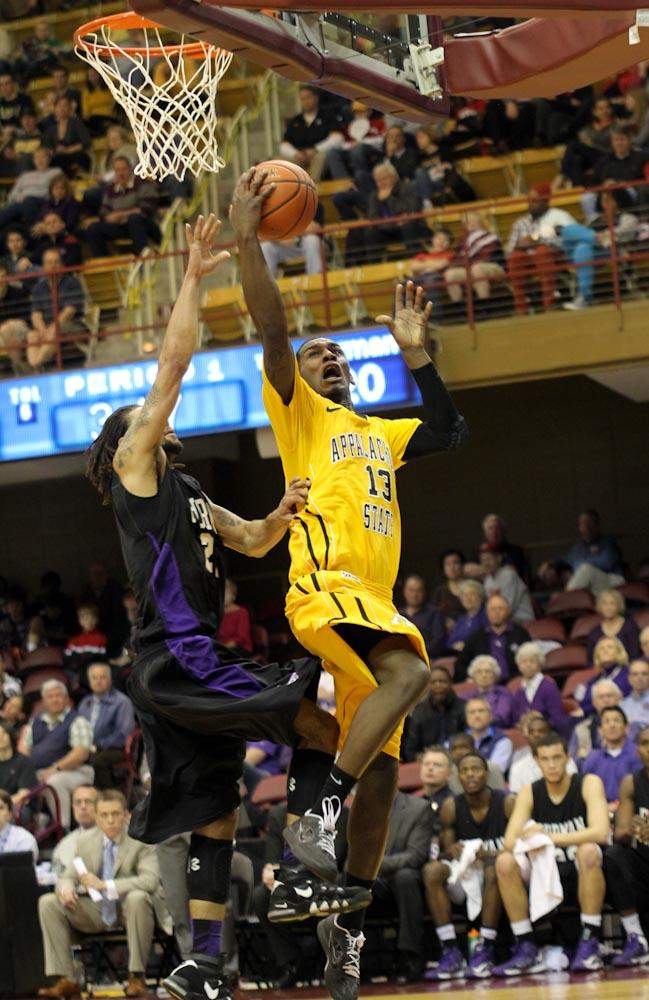 Senior forward Jamaal Trice attempts a layup against a Furman defender in Saturday’s second round of the SoCon Tournament against Furman University. The Mountaineers won 74-60 and secured their advance to the semifinal where they will play Davidson Sunday at 6 p.m. Paul Heckert | The Appalachian