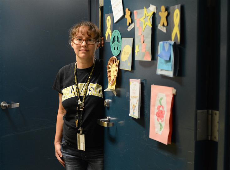 Teresa Davis stands next to her office door, dressed in decorations made by Frank Hall residents. This is Davis’s seventh year working in University Housing. Olivia Wilkes | The Appalachian