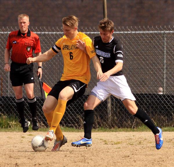 Junior defender Harrison Delbridge keeps the ball from a UNC-Asheville attacker in a game this fall. Justin Perry | The Appalachian