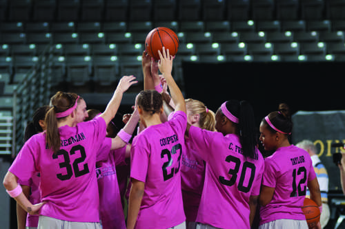 The Mountaineers gather together before a game wearing their breast cancer awareness warm-up shirts. The team is losing four seniors and will need its new upperclassmen to become leaders. Justin Perry | the Appalachian