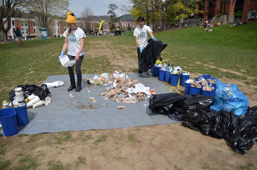 Zero Waste volunteers Christie Horowski and Corie Wallen organize bags of trash into recyclables, trash and compostable materials. They organized 24 bags of trash down to only one bag of trash, the rest being recyclable or compostable. Nicole Debartolo | The Appalachian