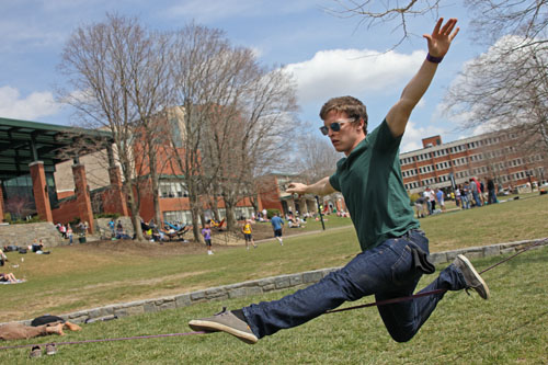 Sophomore recreation management major Matt Edwards takes advantage of the warm weather and slacklines on Sanford Mall on Monday afternoon. Tempuratures are expected to rise in the 70s Tuesday and Wednesday. Paul Heckert | The Appalachian