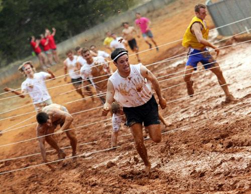 Junior exercise science major Trevor Thomas makes a break from an obstacle in Sunday’s Alpha Delta Pi-sponsored Mud Run held at the High Country Fairgrounds. The run raised $4,872 for the Ronald McDonald House and had 375 participants. Paul Heckert | The Appalachian