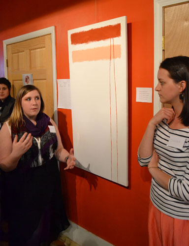 Senior art history major Jasmine Ammon (left) and senior art history and women’s studies major Susan Mackey (right) explain a Rothko-inspired art piece. The painting was one of many pieces by Appalachian State University students on display in Shear Shakti Salon on Friday for the Origins of the World Art Gallery. Mark Kenna | The Appalachian