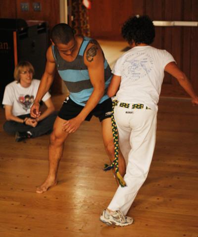 Sophomore management major Josh Blanco (left) practices a capoeira move on lecturer Gabrielle Motta-Passajou (right) in a class offered through the Watauga Global Community. Capoeira is a Brazilian martial art that combines elements of dance and music. There is a workshop followed by a Capoeira performance Friday at 5 p.m. in the Grandfather Ballroom of Plemmons Student Union. Parker Arnold | Courtesy Photo