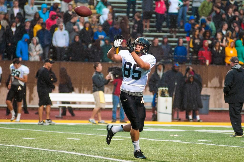 Freshman tight end Barrett Burns warms up before the start of Appalachian Footballs annual Fan Fest on Saturday. Despite constant rain, approximately 4,500 fans showed up to watch the 93-play scrimmage. Justin Perry | The Appalachian