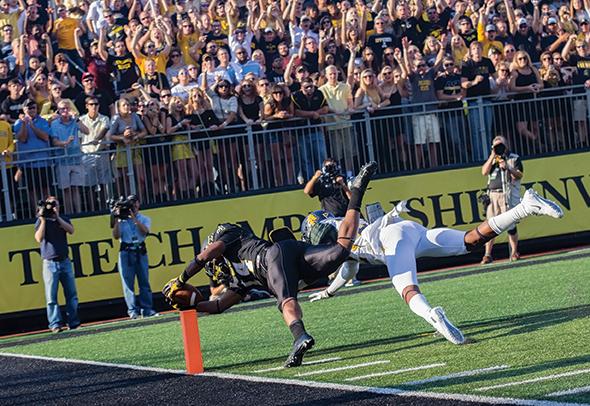 Freshman running back Marcus Cox stretches out for a first quarter touchdown in Saturday’s match-up against N.C. A&T. After a fourth-quarter surge, the team lost to the Aggies 24-21. Photo by Paul Heckert | The Appalachian