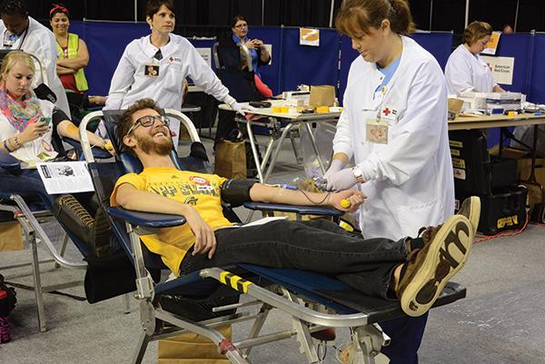 Junior appropriate technology major Matthew Swails smiles while donating blood at the “Saved by the Blood” blood drive. Photo by Courtney Roskos | The Appalachian