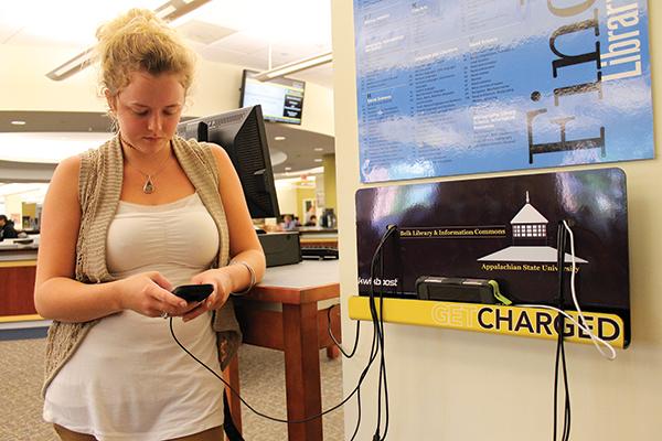 Junior nutrition major Alaina Stacy charges her phone at the first floor &quot;Get Charged&quot; station in Belk Library Tuesday. The &quot;Get Charged&quot; stations are complete with cell phone chargers for most models.&quot;I lose my cords all the time,&quot; Stacy said, &quot;so the charging stations are very convenient.&quot; Photo by Molly Cogburn | The Appalachian