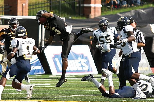 Wide receiver Tony Washington hurdles over a Chattanooga defender during the Mountaineers’ 14-12 victory over Chattanooga during the 2011 season. Appalachian State will face Chattanooga at Kidd Brewer Stadium on Saturday. File Photo | The Appalachian