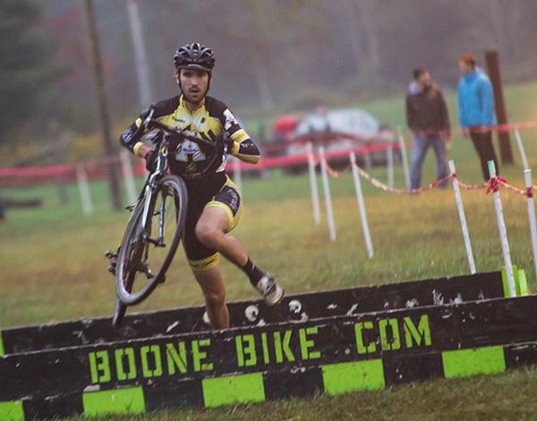 Junior appropriate technology major Baird Sills dismounts to hop a barrier during the Boone Bike and Touring sponsored cyclocross race. Photo by Paul Heckert | The Appalachian