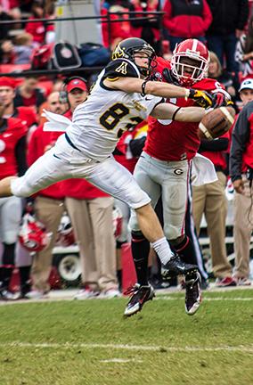Sophomore wide receiver Simms McElfresh’s catch is disrupted by a Georgia defender during Saturday’s game. Despite a strong first quarter, the Bulldogs bit straight through the Mountaineers for a 45-6 win. Photo by Paul Heckert | The Appalachian