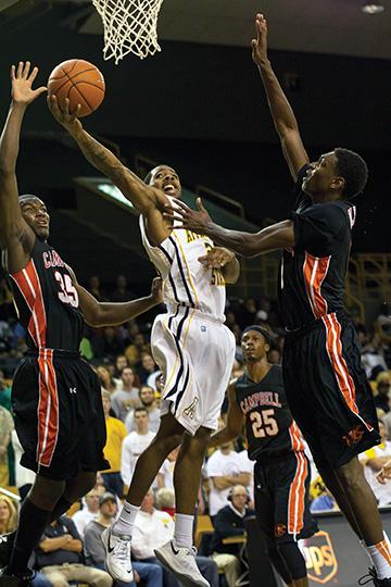 Junior guard Mike Neal squeezes through the defense toward the basket during Tuesday night’s home opener against Campbell. The Camels beat the Mountaineers 73-66. Photo by Paul Heckert | The Appalachian