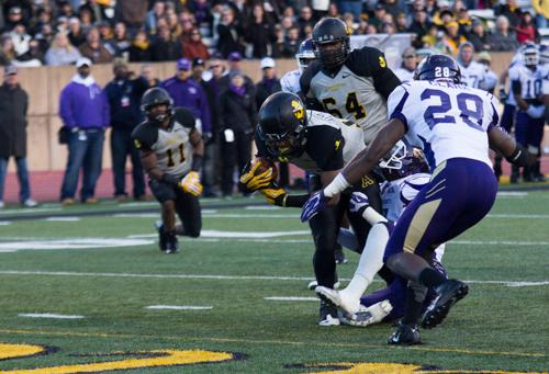 Freshman running back Marcus Cox breaks through two Western defenders for a touchdown in the Mountaineers 48-27 win over Western Carolina. Paul Heckert | The Appalachian