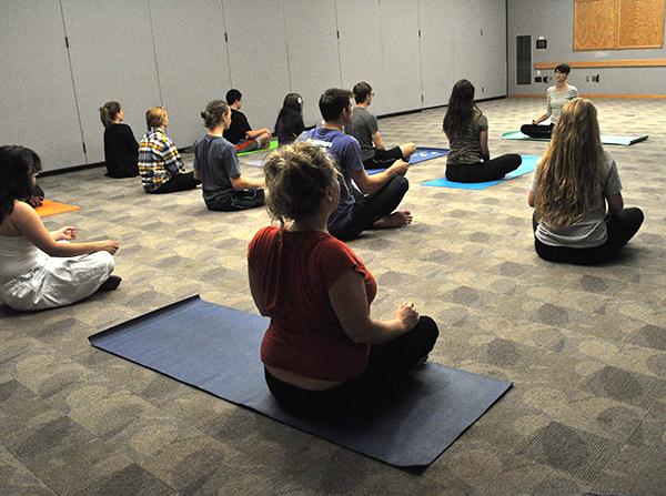 Students practiced yoga and meditation Tuesday in the Attic Window room of the student union. Yesplus yoga is held every Tuesday from 5-6 p.m. Photo by Maggy Boutwell | The Appalachian