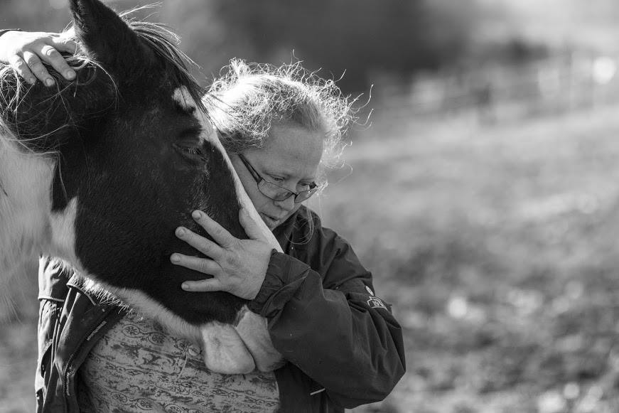 Amy Hudnall, ASU lecturer and president of Horse Helpers of the High Country, embraces one of the
horses the organization has rescued from abuse, abandonment or neglect. Photo by Chris Deverell  |  The Appalachian