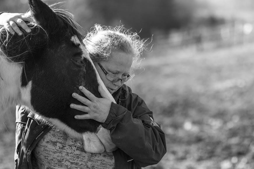 Amy Hudnall, ASU lecturer and president of Horse Helpers of the High Country, embraces one of the horses the organization has rescued from abuse, abandonment or neglect. Photo by Chris Deverell  |  The Appalachian