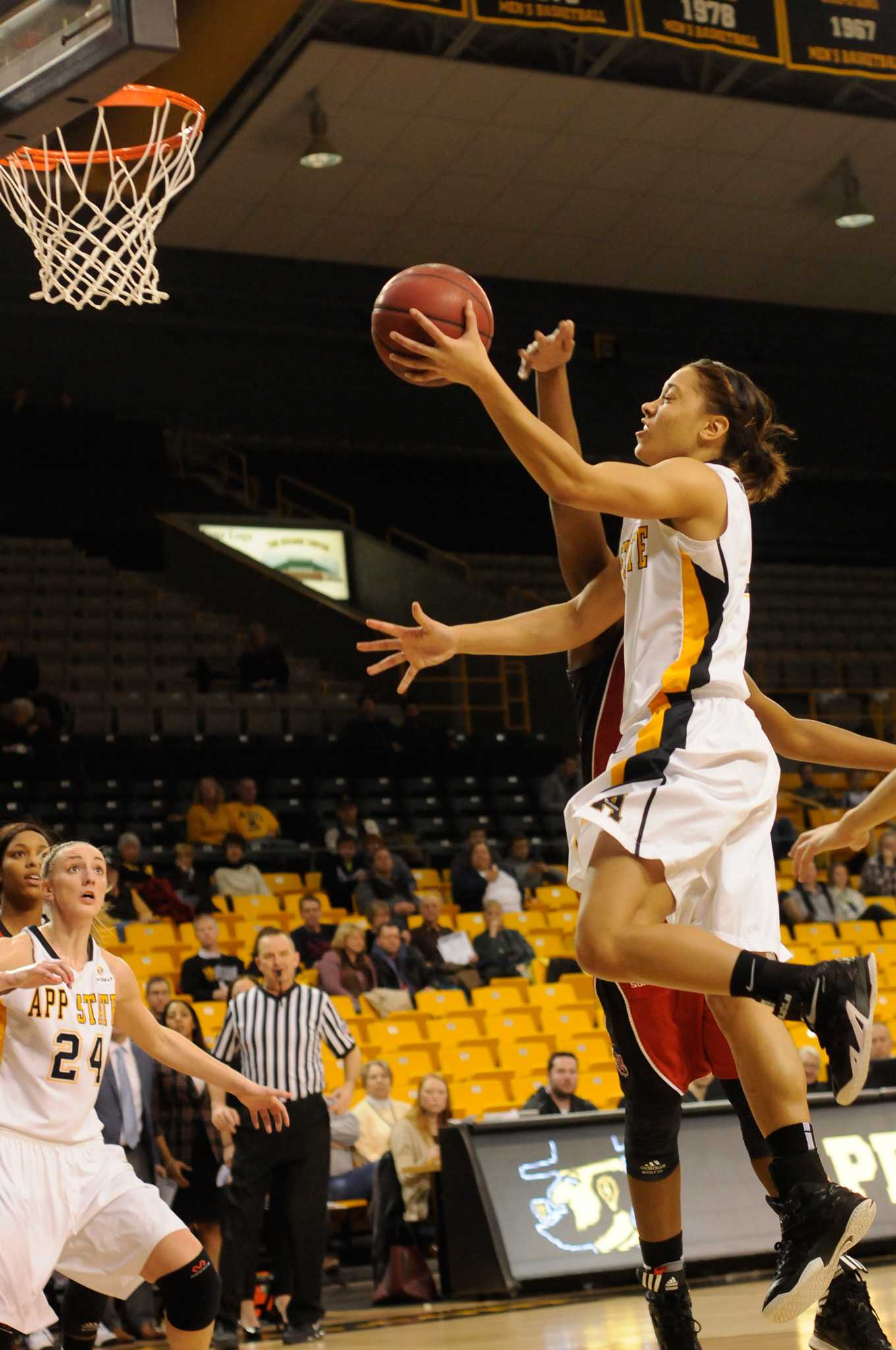 Sophomore guard Bria Carter drives to the basket against the Arkansas State defense Thursday. The Mountaineers were able to recover from a 15 point deficit in the last ten minutes of play, securing a 70-69 win over the first-place ranked Red Wolves. Photo by Justin Perry  |  The Appalachian
