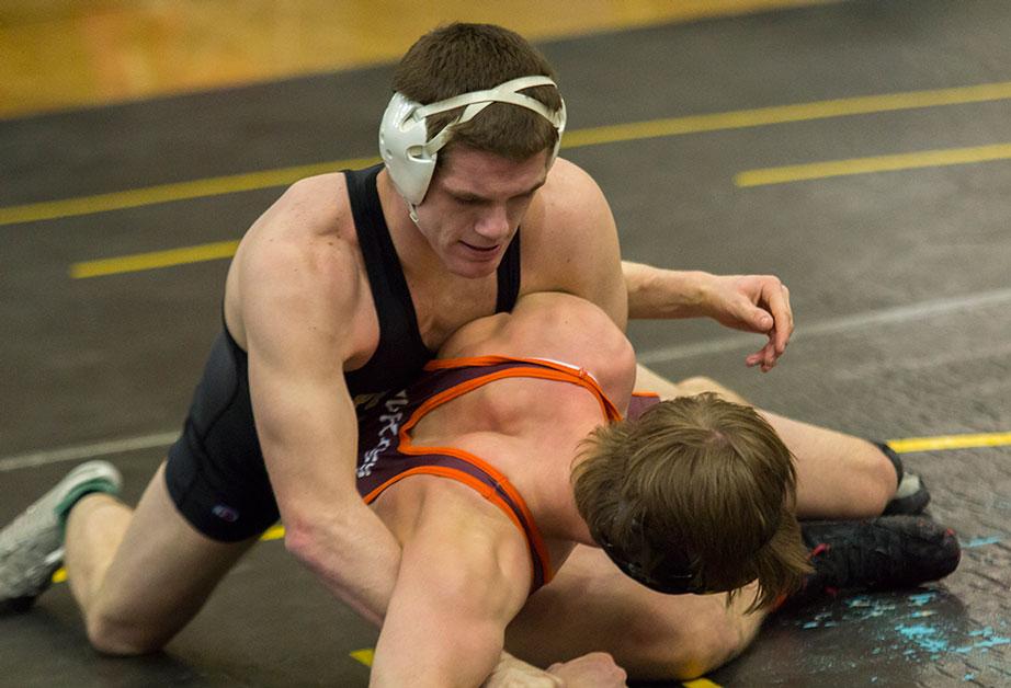Senior Collins Creech keeps hold of Virginia Tech wrestler early on in Saturdays tournament held in the Varsity Gym. Photo by Paul Heckert  |  The Appalachian