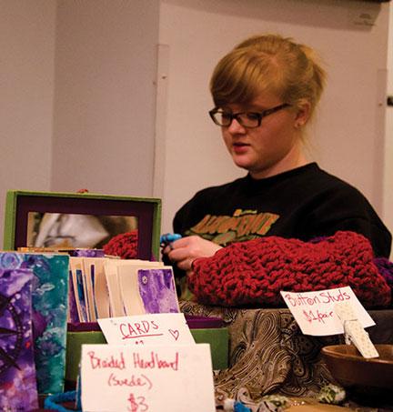 Lindsey Hoffman, sophomore sociology major, crochets at her table in the Old Time Fiddlers Convention craft market. The market draws artisans from the community each year. Photo by Kim Reynolds  |  The Appalachian