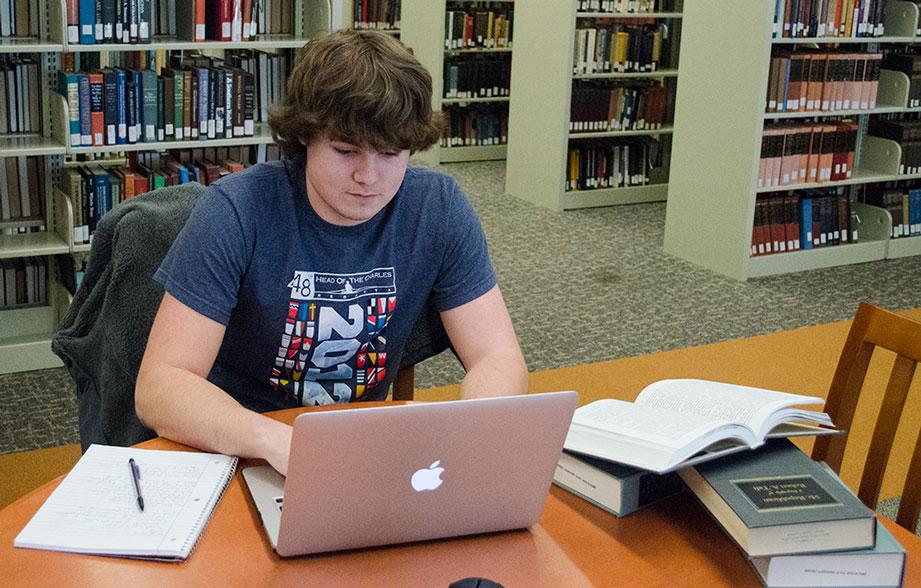 Freshman management major Conner Drummond studying at the Belk Library Wednesday afternoon. Drummond uses all that he has learned academically to help others with their work through his website www.hwlocker.com. 