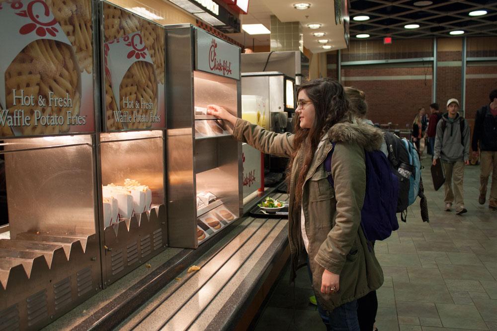 Junior psychology major Kaity Pechanek picks up dinner from the Chik-fil-A, located in Central Dining Hall. SGA is currently working with Food Services to create late-night dining on campus along with offering Chik-fil-A breakfast. Photo by Rachel Krauza  |  The Appalachian