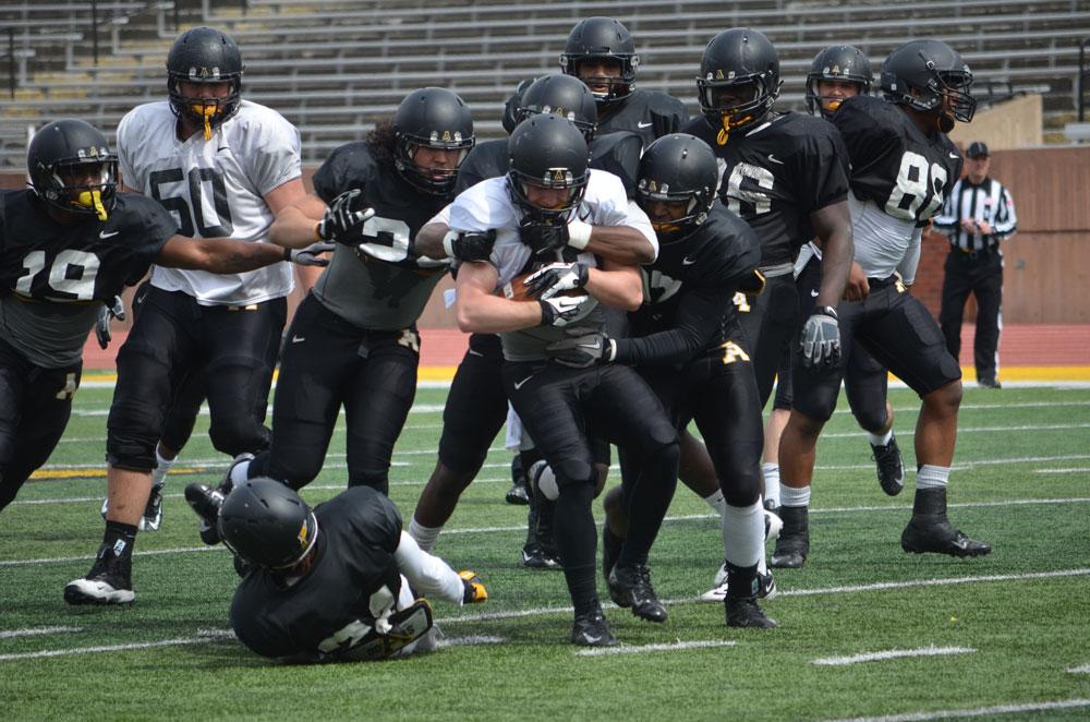 Junior+wide+receiver+Simms+McElfresh+fights+off+a+group+of+tacklers+during+a+full-contact+spring+scrimmage+last+Saturday+at+Kidd+Brewer+Stadium.++Photo+by+Corey+Spiers++%7C++The+Appalachian