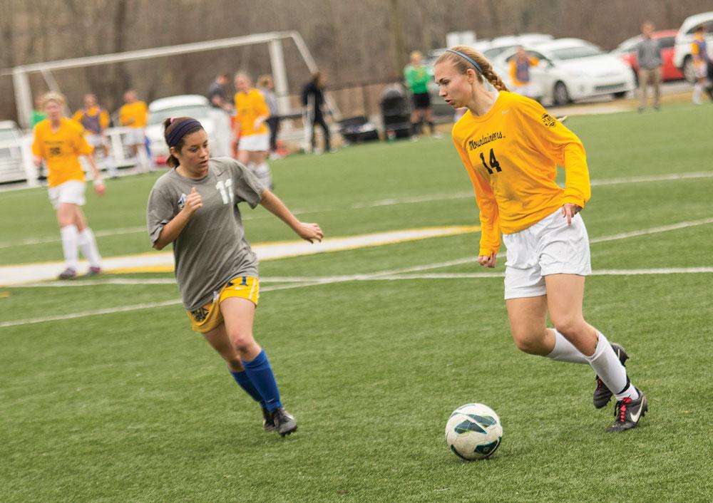 Sophomore+forward+Samantha+Childress+%28right%29+dribbles+around+a+Mars+Hill+defender+in+the+opening+game+of+Appalachian+State%E2%80%99s+spring+schedule.+The+Mountaineers+won+6-0.++Photo+by+Paul+Heckert++%7C++The+Appalachian