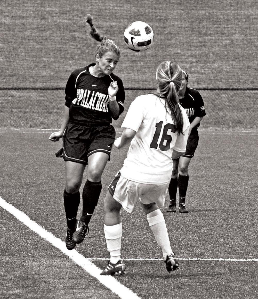 An Appalachian State soccer player heads the ball. Brittany Bolick will join the Appalachian State women’s soccer coaching staff next season as the team joins the Sun Belt Conference. Photo by Olivia Wilkes  |  The Appalachian