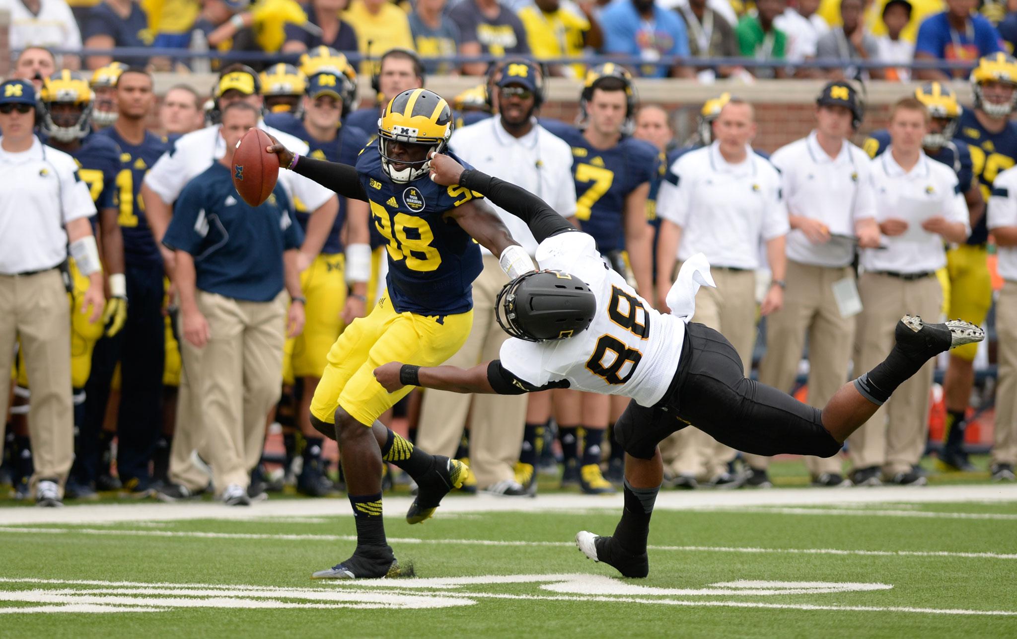 Sophomore wide receiver Jaquil Capel attempts to take down the Michigan offense during the first half of Saturdays season opening game against Michigan. The Wolverines defeated the Mountaineers 52-14. Photo by Justin Perry  | The Appalachian