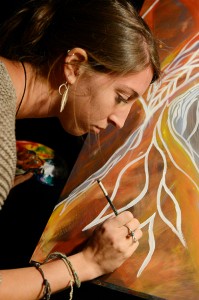 Appalachian alumna Darcy Wade paints on stage during band Nomadic's performance during last year's Harvest Boone. Photo by Olivia Wilkes  |  The Appalachian