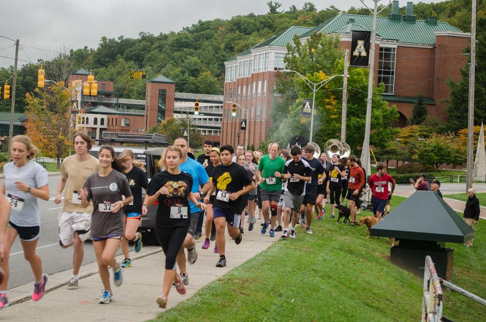 Runners beginning their race for the finish line at the Music Moves My Sole 5k held by Split Rail Records at Duck Pond Saturday morning. The event was held to show support and raise awareness for local musicians. Photo by Morgan Cook  |  The Appalachian