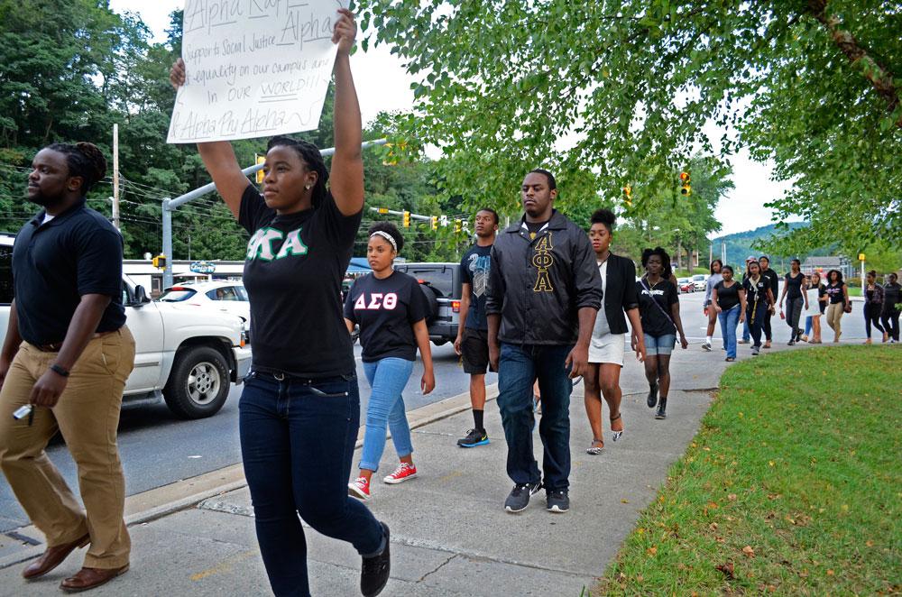Students from the university and the Black Student Association participating in the Black Lives Matter Walk Wednesday evening. The walk began at the Yosef statue and ended at Sanford Mall. Photo by Nicole Debartolo  |  The Appalachian