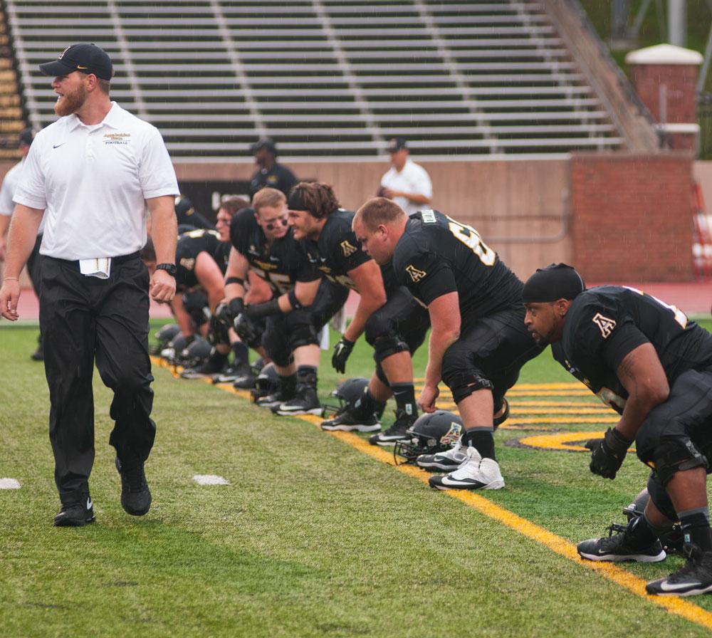 Co-Offenisive Coordinator Dwayne Ledford leads the Appalachian State football players in warm ups at last Saturday's game against Campbell University at Kidd Brewer Stadium. Photo by Rachel Krauza  |  The Appalachian