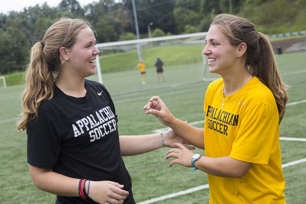 Freshman+goalkeeper+Sam+Steyl+%28left%29+and+senior+defender+Nicole+Steyl+%28right%29+take+a+moment+after+a+Wednesday+morning+practice+a+Ted+Mackrel+Soccer+Complex.+The+two+are+teammates+as+well+as+sisters.+It+has+been+three+years+since+the+two+played+together+on+the+same+team.+Photo+by+Paul+Heckert++%7C++The+Appalachian