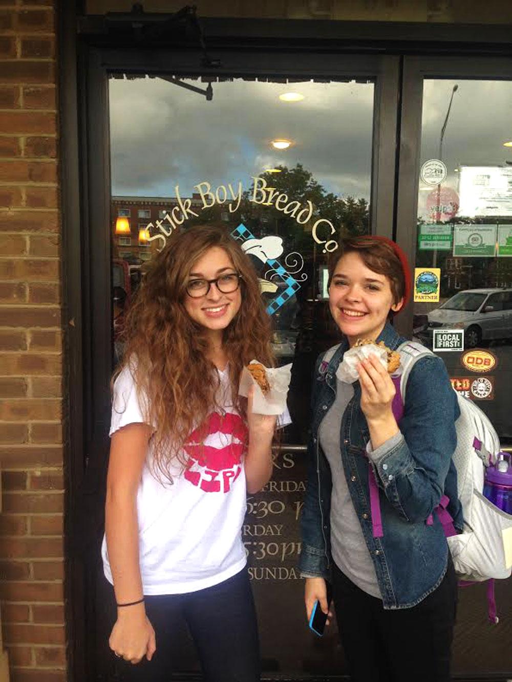 Undeclared sophomore Kyra Kapsaskis (left) and freshman exercise science major Alaina Swick (right) enjoying free cookies Tuesday afternoon at Stick Boy Bread Company to celebrate 13 years of business. Photo by Carson Hager  |  The Appalachian