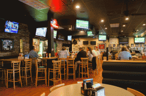 Customers enjoy wings Monday evening at The Rock Sports Bar and Grill. The restaurant serves 45 cent wings every Monday from 4 p.m. until close. Photo by Morgan Cook  |  The Appalachian