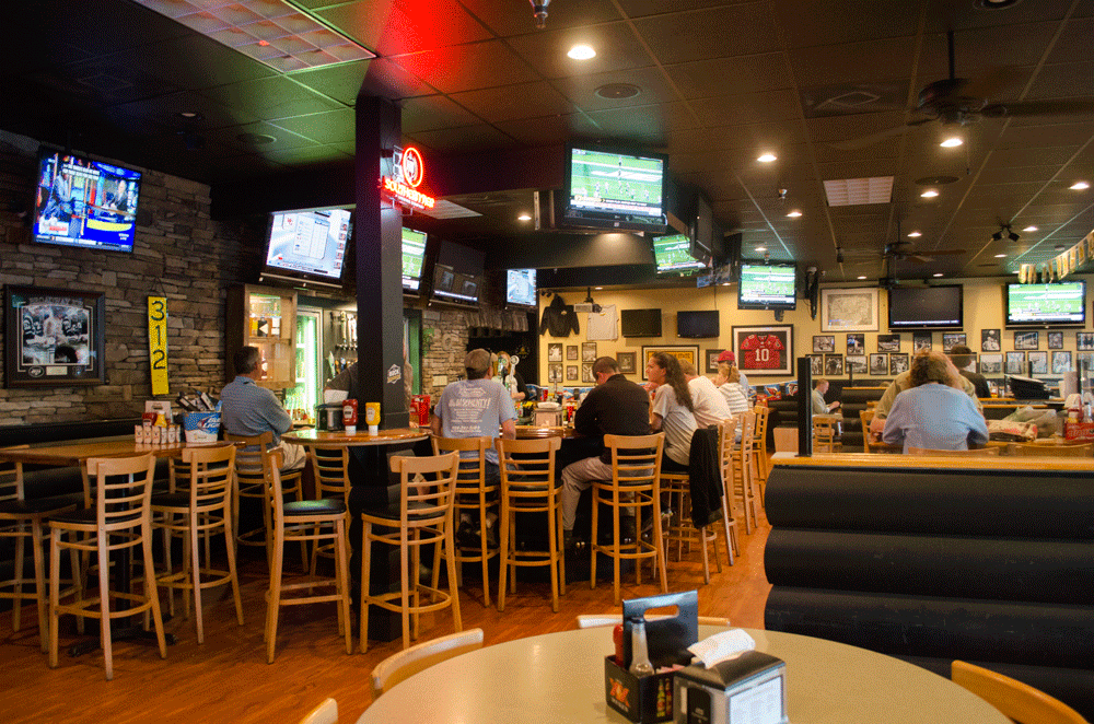 Customers enjoy wings Monday evening at The Rock Sports Bar and Grill. The restaurant serves 45 cent wings every Monday from 4 p.m. until close. Photo by Morgan Cook  |  The Appalachian